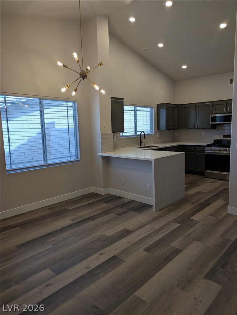 327 Perry Ellis Drive Henderson, NV 89014 - Photo 47 of 54 This kitchen features sleek countertops, modern appliances, and high ceilings creating an inviting atmosphere.