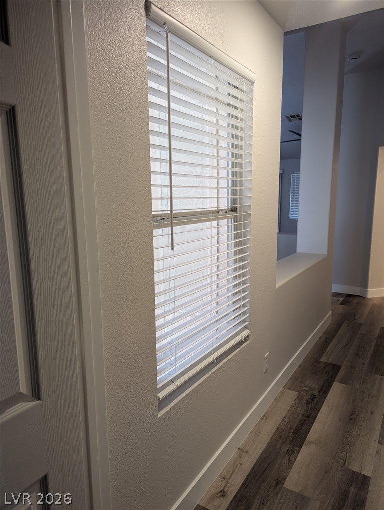 327 Perry Ellis Drive Henderson, NV 89014 - Photo 54 of 54 This interior hallway features sleek flooring, a modern window, and a clear open floorplan.