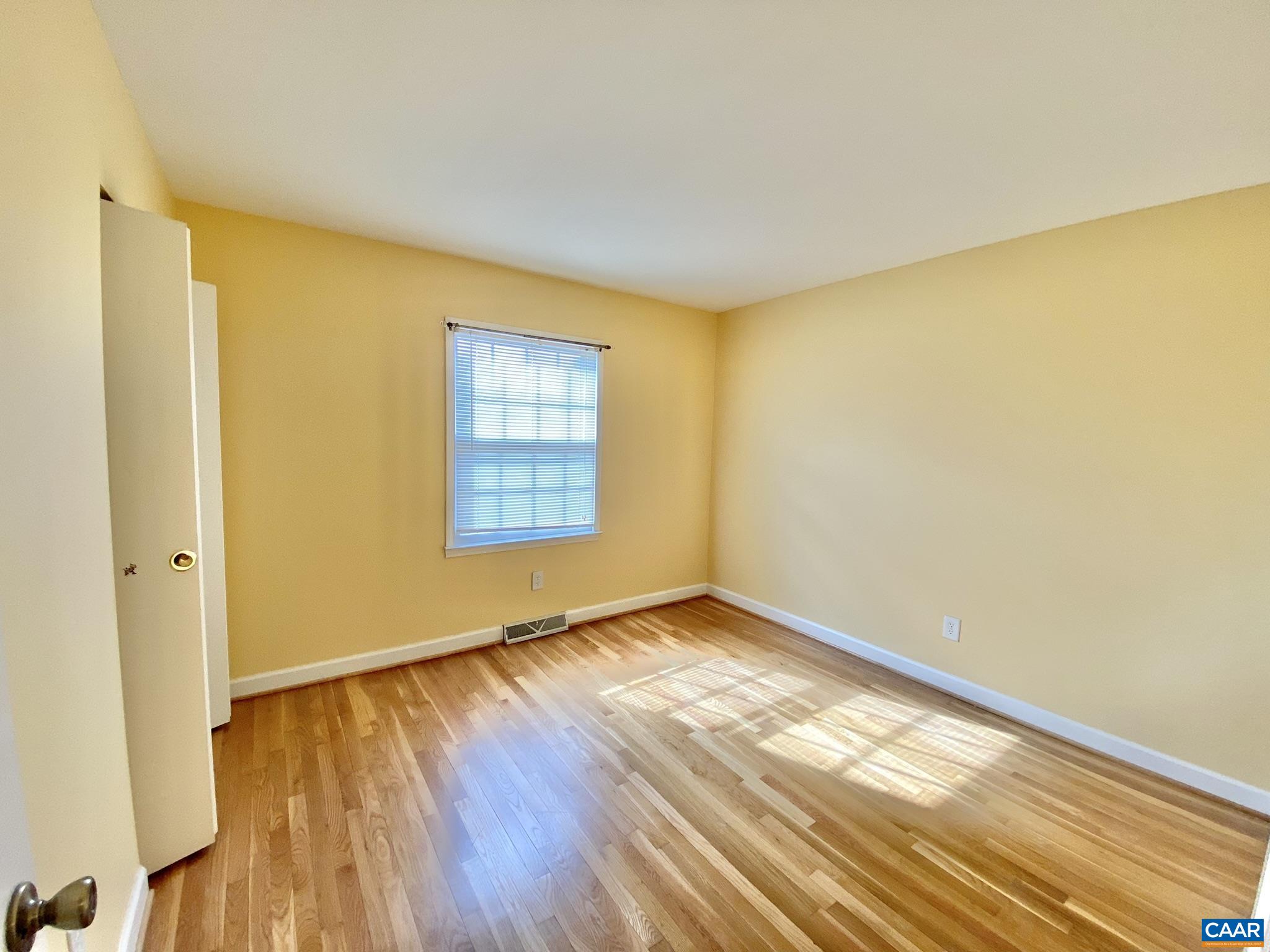 115 Hessian Hills Ridge, Unit 1 Charlottesville, VA 22901 - Photo 13 of 18 a view of an empty room with wooden floor and a window