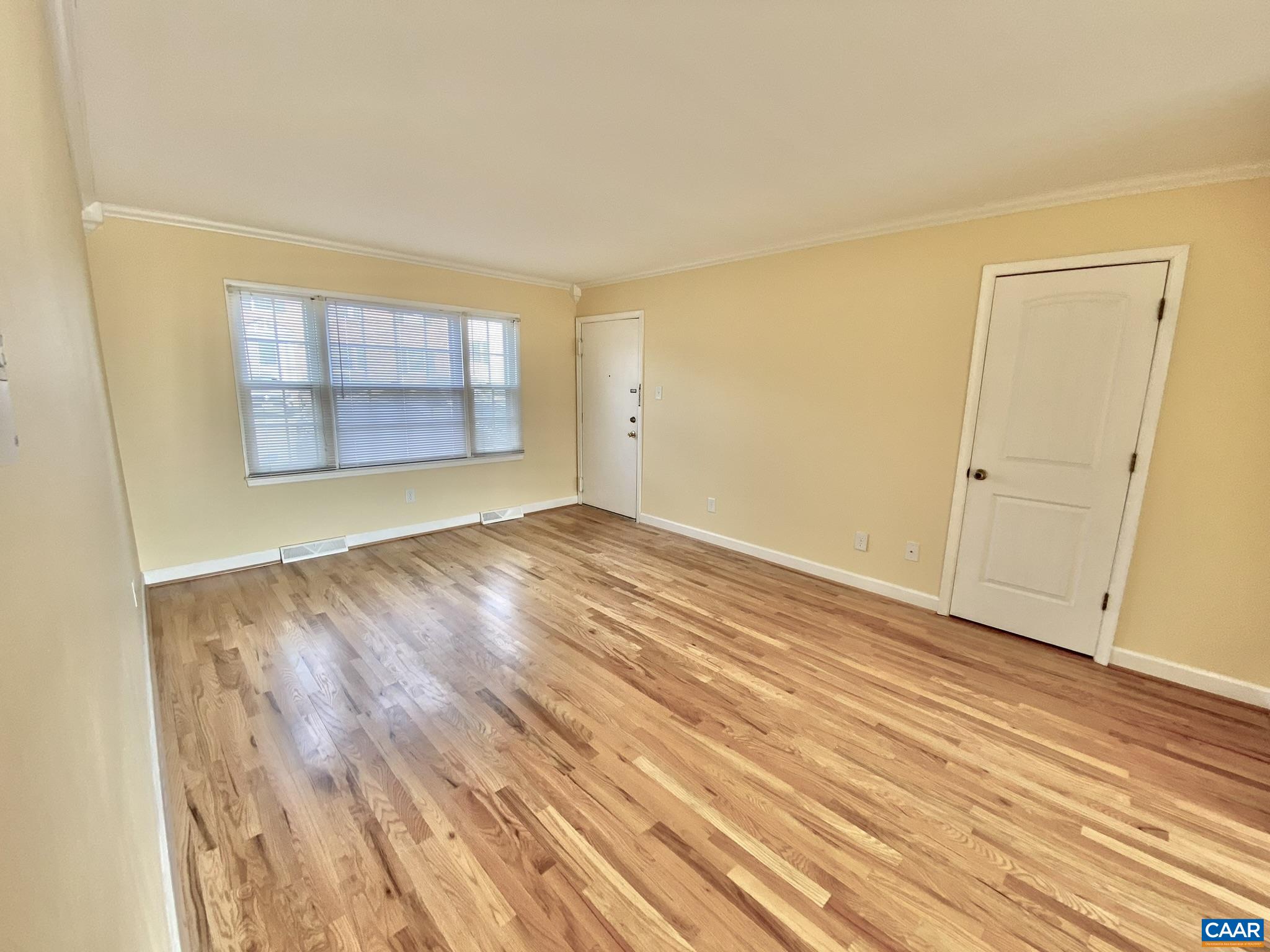 115 Hessian Hills Ridge, Unit 1 Charlottesville, VA 22901 - Photo 16 of 18 an empty room with wooden floor and windows