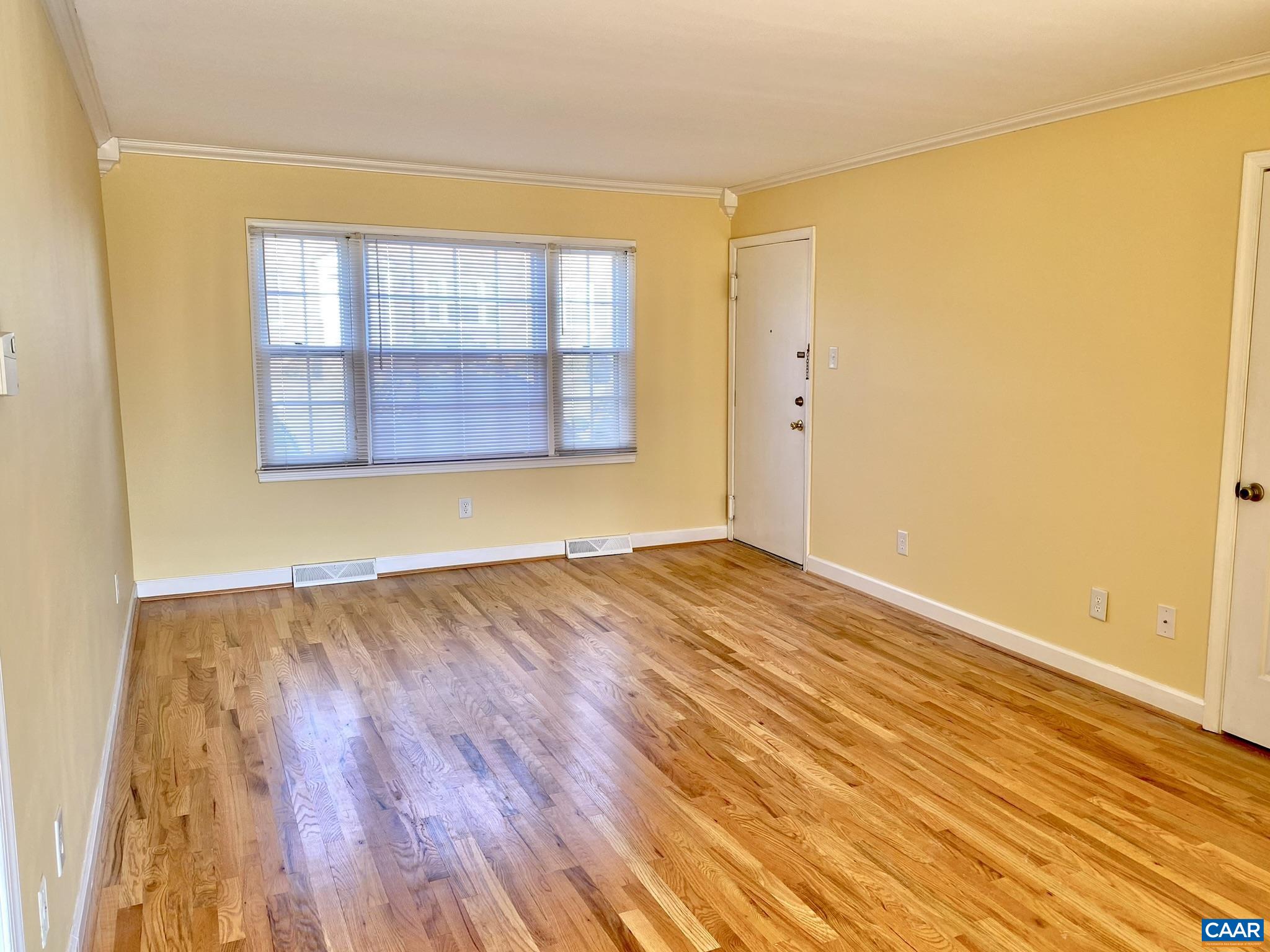 115 Hessian Hills Ridge, Unit 1 Charlottesville, VA 22901 - Photo 6 of 18 an empty room with wooden floor and windows