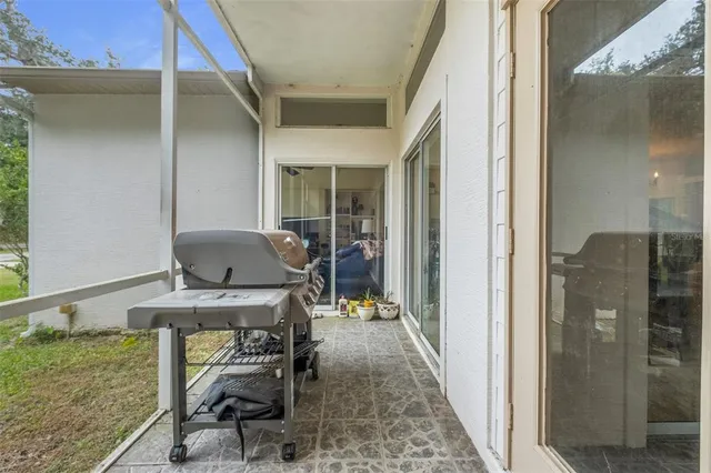 a living room with furniture and a dining table with wooden floor