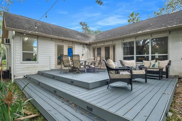 a view of a patio with couches table and chairs and potted plants
