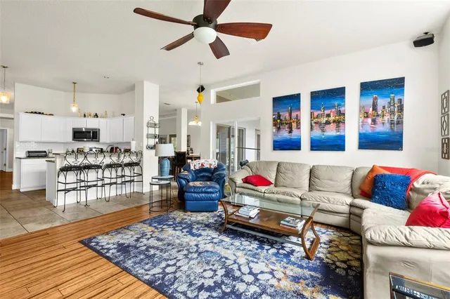 a living room with furniture and wooden floor