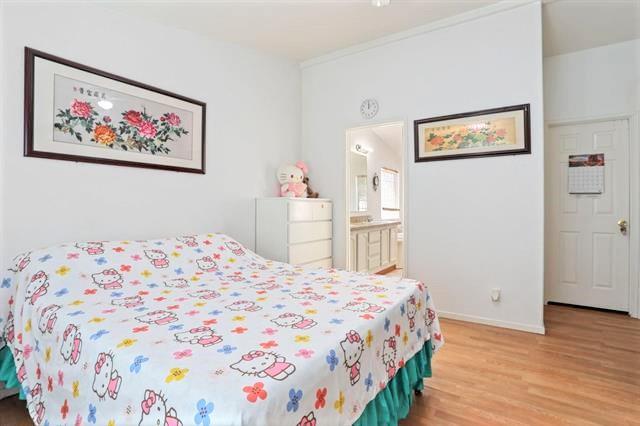 708 Spindrift Drive, Unit 708 San Jose, CA 95134 - Photo 14 of 18 a bedroom with a bed and a painting on the wall