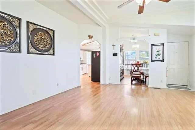 a view of a room with wooden floor and furniture