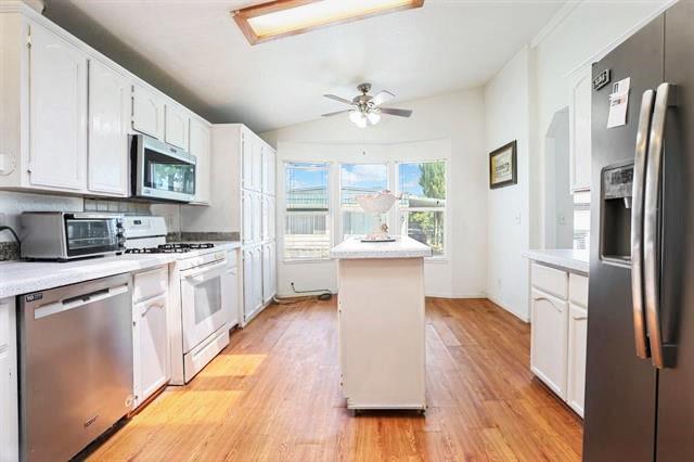 708 Spindrift Drive, Unit 708 San Jose, CA 95134 - Photo 9 of 18 a kitchen with stainless steel appliances a refrigerator sink and cabinets