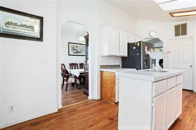 a kitchen with a refrigerator and a stove