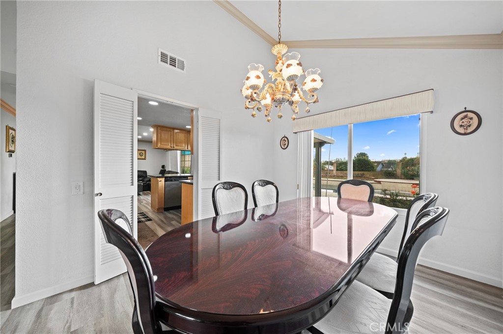 19528 Spinning Wheel Road Walnut, CA 91789 - Photo 11 of 40 a view of a dining room with furniture a chandelier and wooden floor
