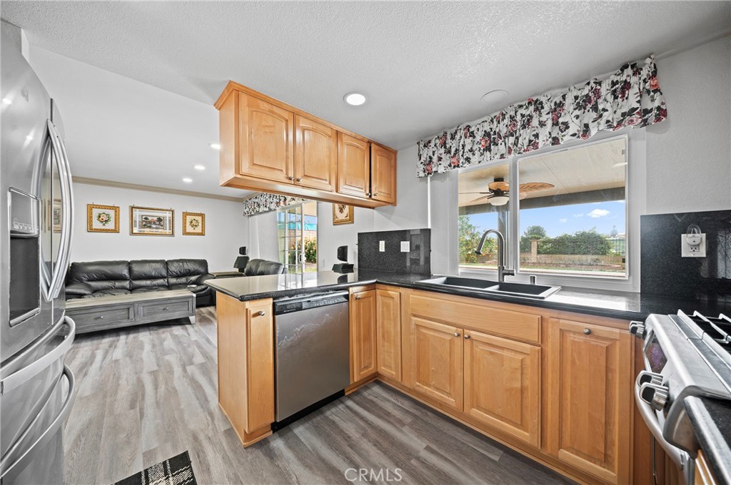 19528 Spinning Wheel Road Walnut, CA 91789 - Photo 12 of 40 a kitchen with stainless steel appliances granite countertop a sink and wooden cabinets