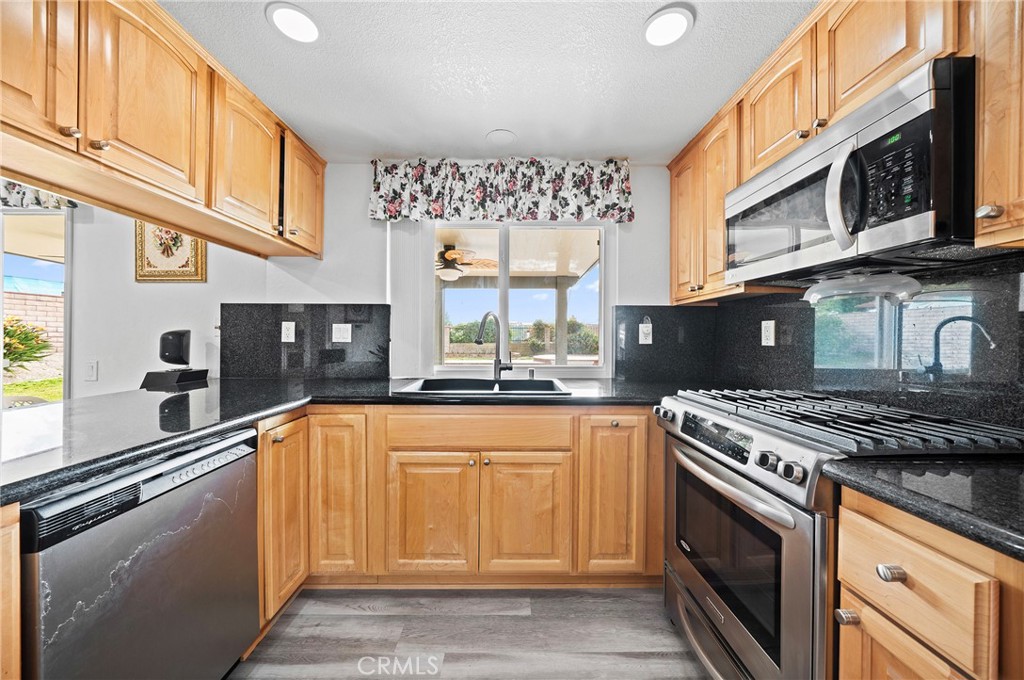 19528 Spinning Wheel Road Walnut, CA 91789 - Photo 15 of 40 a kitchen with stainless steel appliances granite countertop a stove sink and cabinets