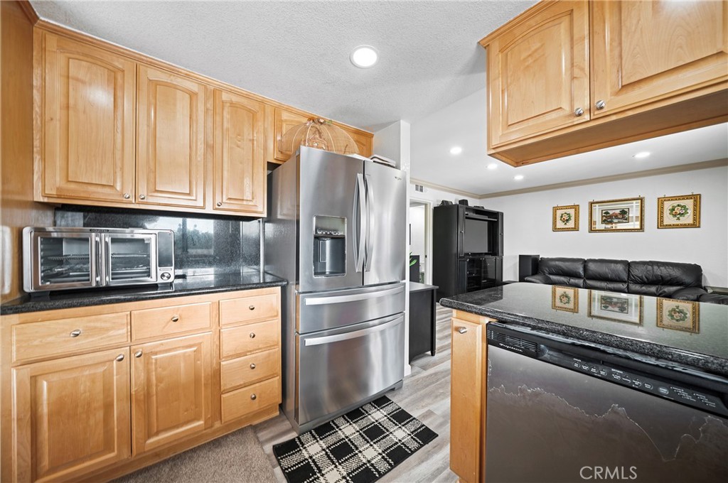 19528 Spinning Wheel Road Walnut, CA 91789 - Photo 17 of 40 a kitchen with granite countertop a refrigerator stove and cabinets