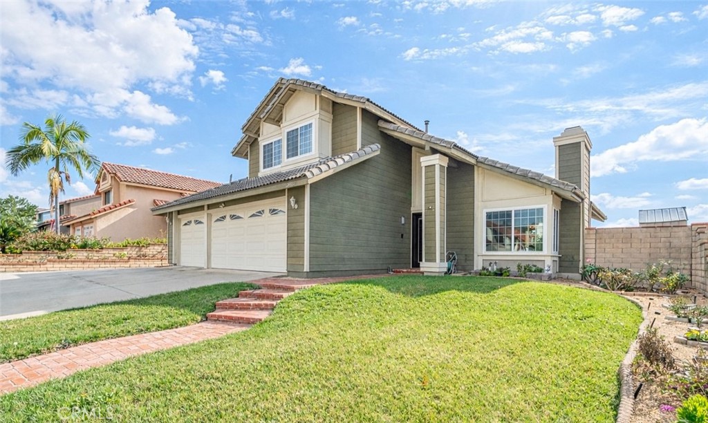 19528 Spinning Wheel Road Walnut, CA 91789 - Photo 2 of 40 a front view of a house with a yard and garage