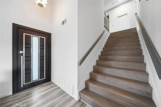 a view of a hallway with wooden floor and entryway