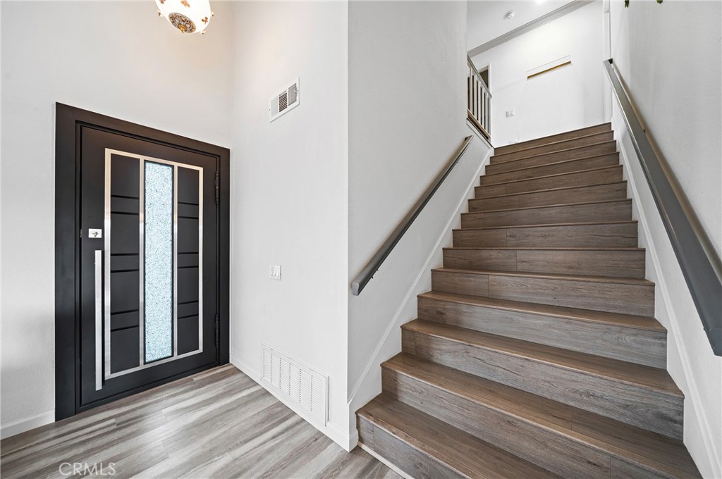 19528 Spinning Wheel Road Walnut, CA 91789 - Photo 21 of 40 a view of a hallway with wooden floor and entryway