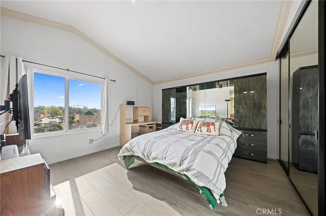 a bedroom with a large bed and a large window