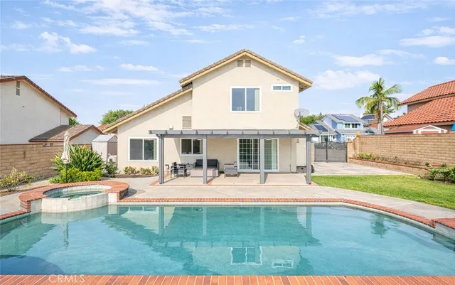 a view of a house with backyard and sitting area