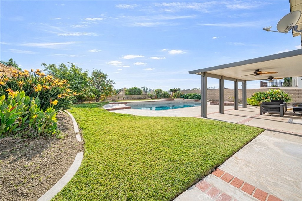 19528 Spinning Wheel Road Walnut, CA 91789 - Photo 4 of 40 a view of a swimming pool with an outdoor space and seating area
