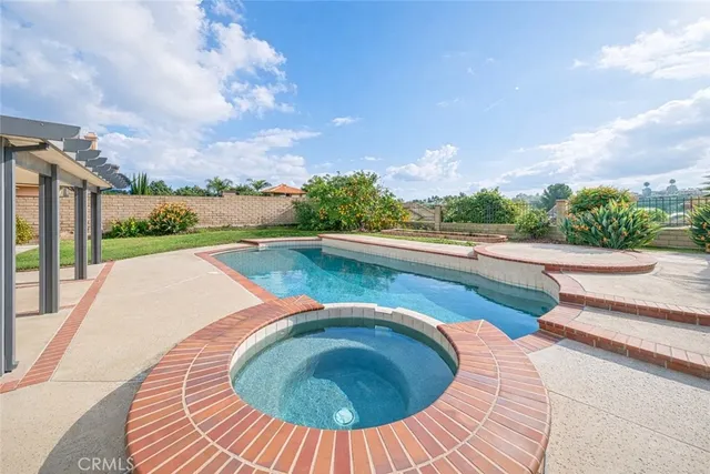 a view of swimming pool with seating space