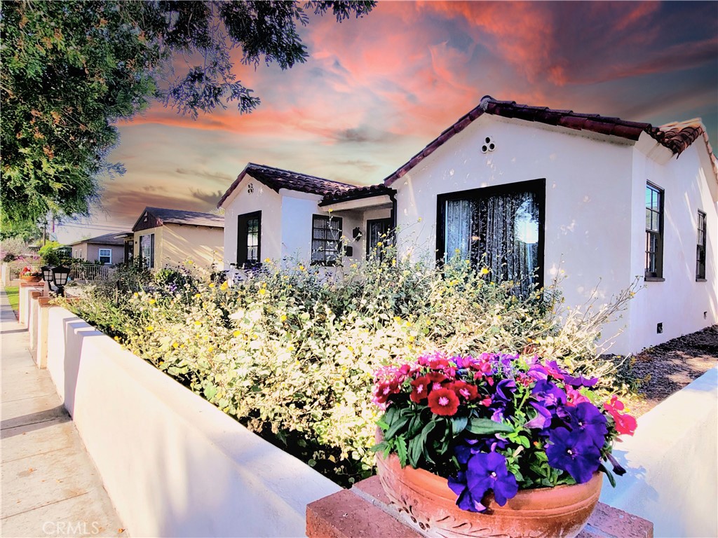 2427 Pine Avenue Long Beach, CA 90806 - Photo 1 of 24 a flower garden is sitting in front of a house