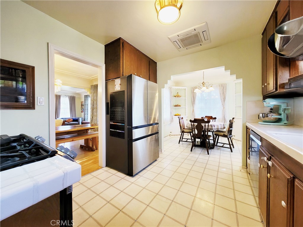 2427 Pine Avenue Long Beach, CA 90806 - Photo 13 of 24 a kitchen with a refrigerator and a stove top oven