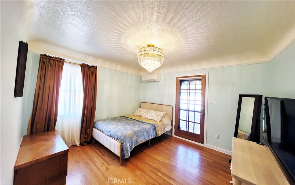 2427 Pine Avenue Long Beach, CA 90806 - Photo 16 of 24 a bedroom with a bed and window