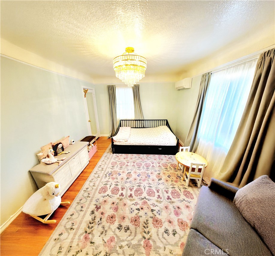 2427 Pine Avenue Long Beach, CA 90806 - Photo 17 of 24 a bed sitting in a bedroom next to a window