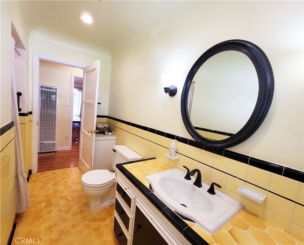 2427 Pine Avenue Long Beach, CA 90806 - Photo 19 of 24 a bathroom with a sink and a mirror