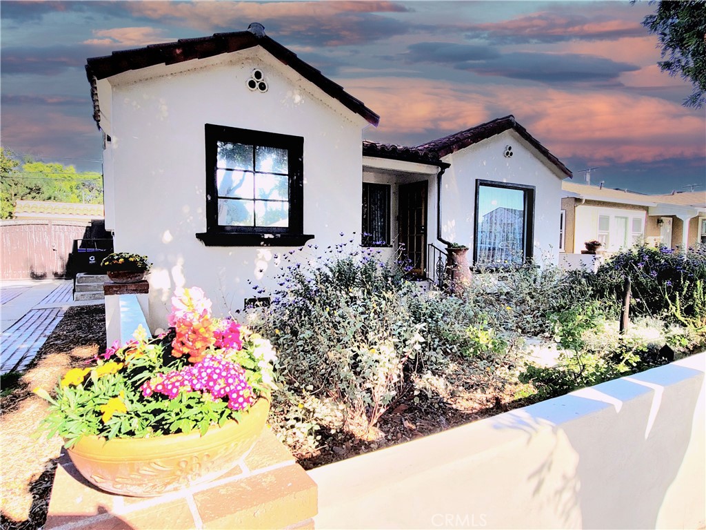 2427 Pine Avenue Long Beach, CA 90806 - Photo 3 of 24 a front view of a house with a yard
