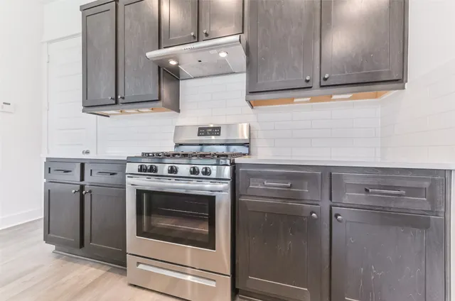 a kitchen with granite countertop cabinets and steel stainless steel appliances