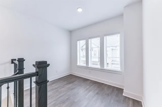 a view of a livingroom with wooden floor and a window