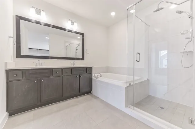 a bathroom with a mirror a bathtub and a shower