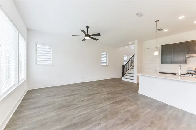 a view of a kitchen with a sink and a window