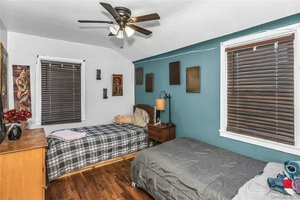 a bedroom with two beds and a large window