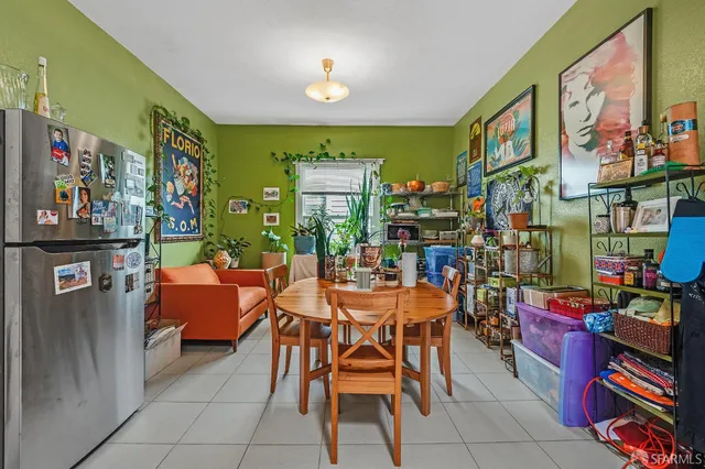 a dining room filled with furniture and a potted plant