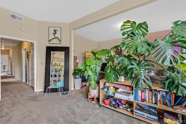 a bedroom with a bed and a book shelf