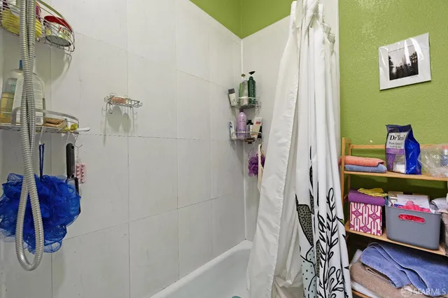 a bed sitting in a bedroom next to a window with potted plant