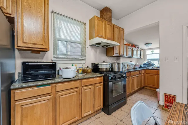 a living room with furniture a flat screen tv and a dining table