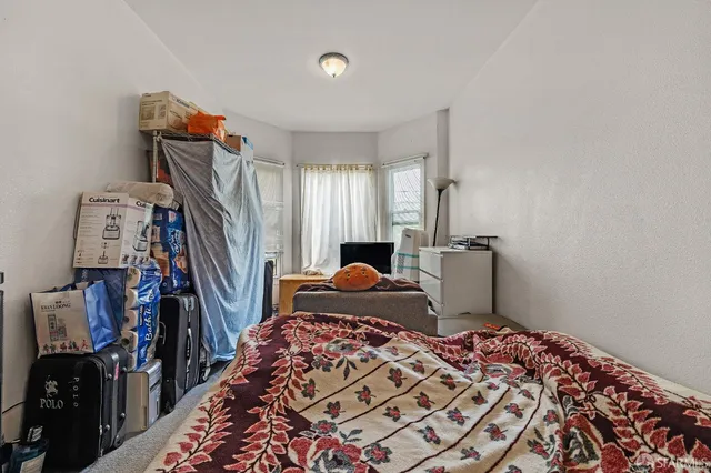 a bedroom with a bed and a chair