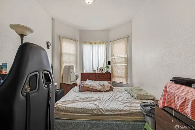 a bedroom with furniture and a window