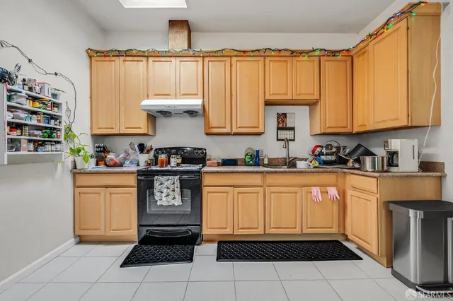 a kitchen with a white cabinets and white appliances