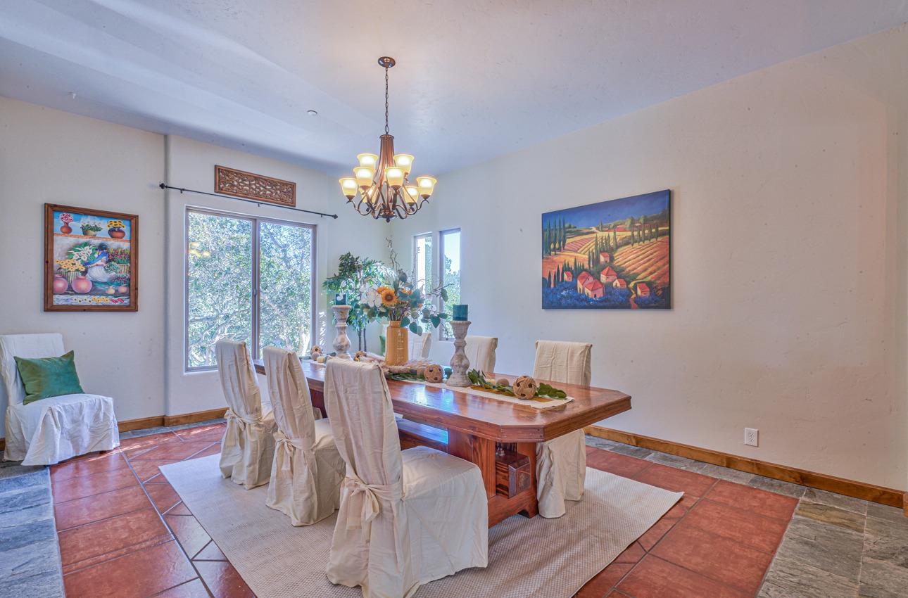 7382 Timeview Way Salinas, CA 93907 - Photo 13 of 79 a dining room with furniture a rug a painting and a chandelier