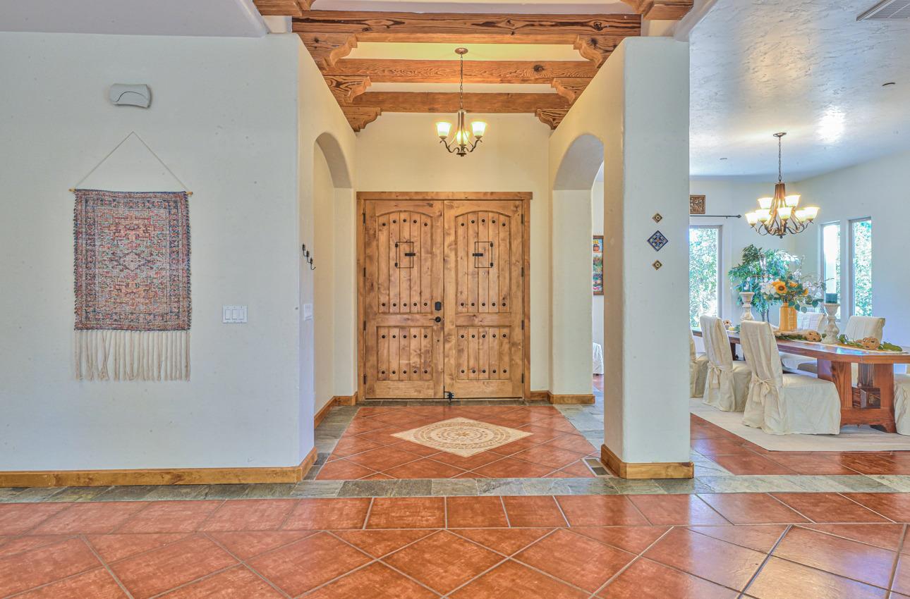 7382 Timeview Way Salinas, CA 93907 - Photo 17 of 79 a view of a hallway with wooden floor and a chandelier