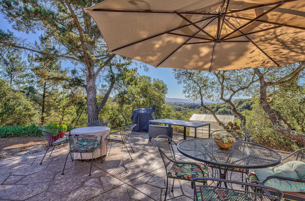 7382 Timeview Way Salinas, CA 93907 - Photo 31 of 79 a view of a backyard with table and chairs under an umbrella