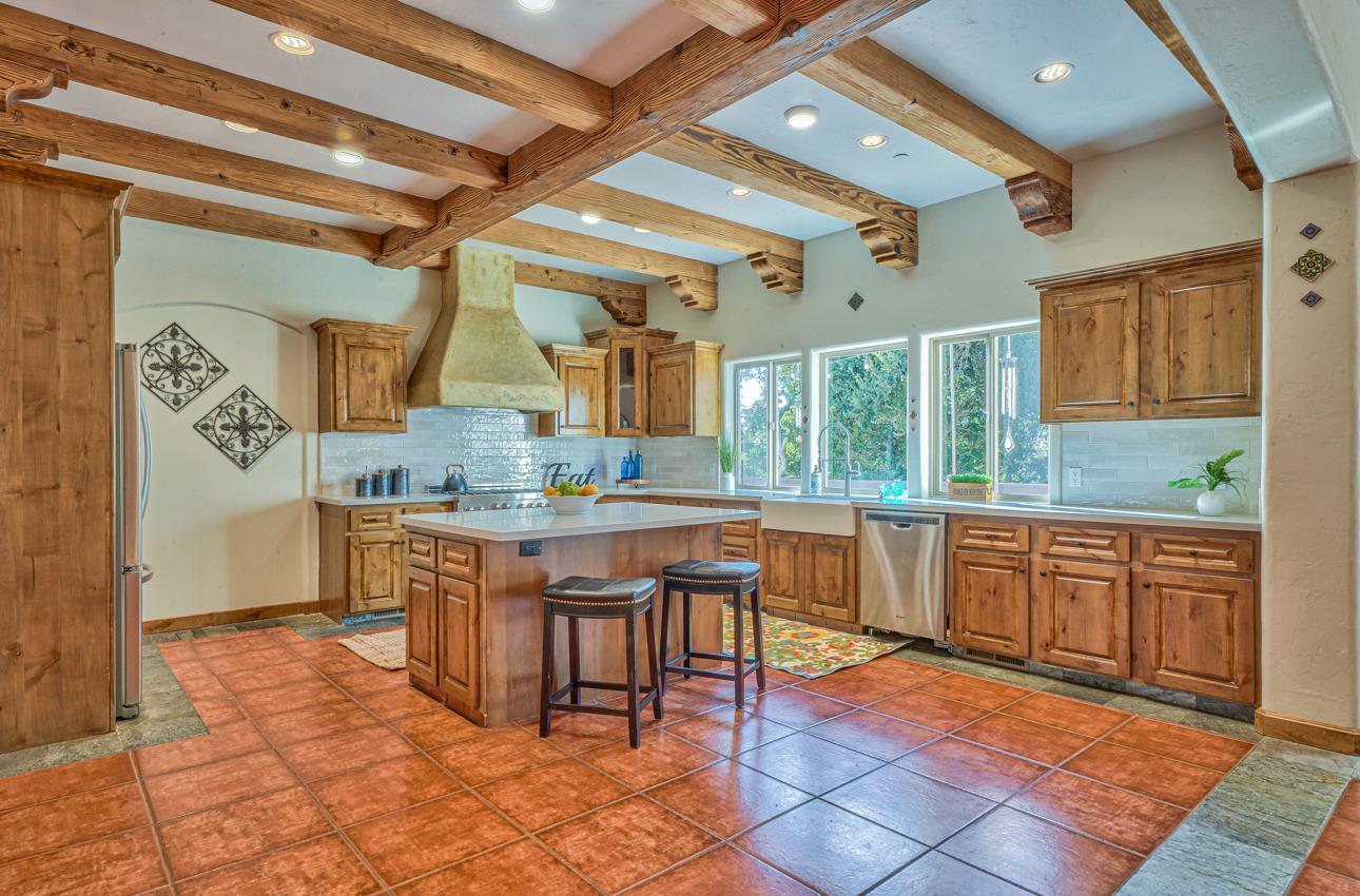 7382 Timeview Way Salinas, CA 93907 - Photo 7 of 79 a large kitchen with kitchen island granite countertop wooden cabinets a counter and a sink
