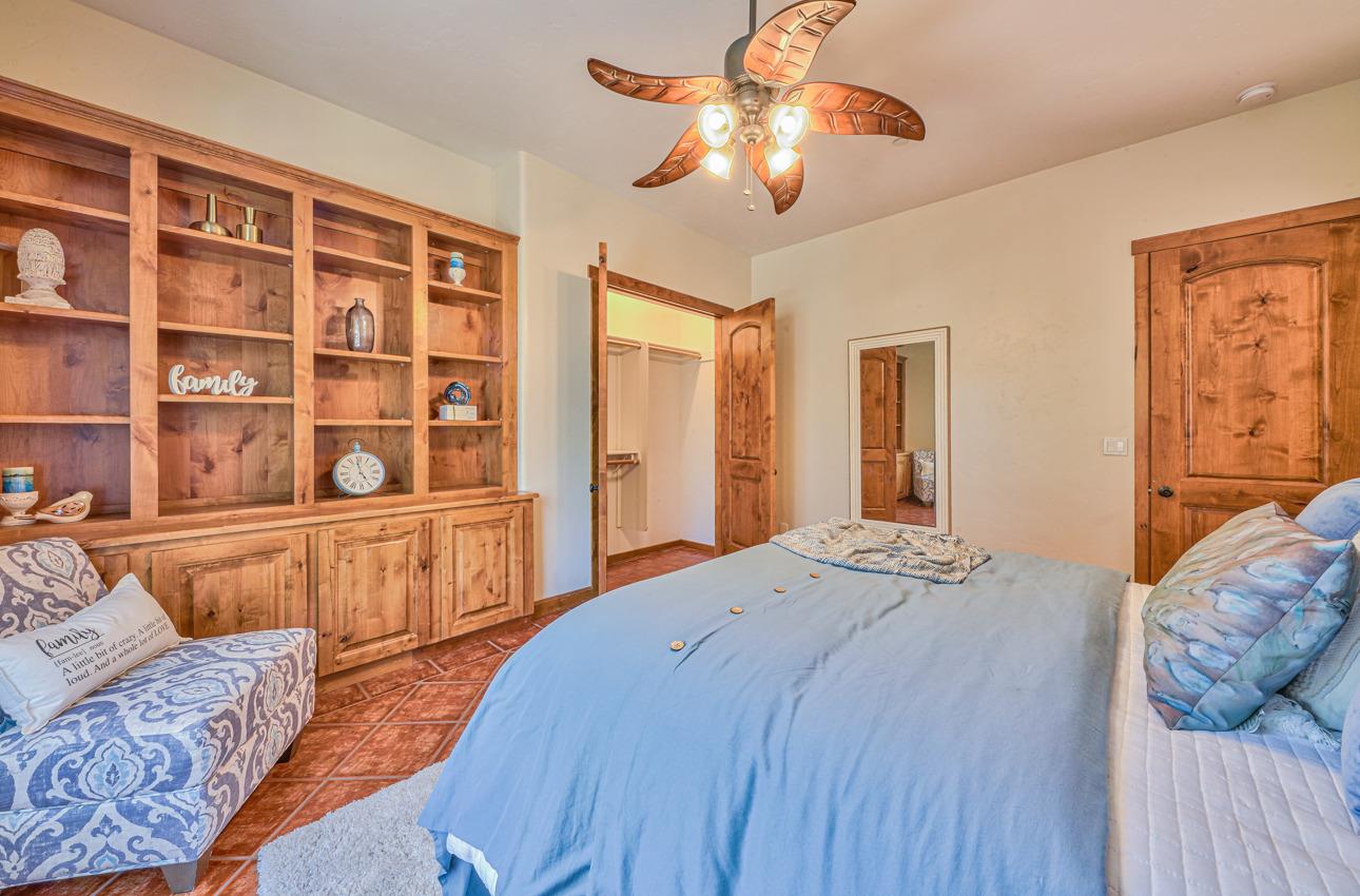 7382 Timeview Way Salinas, CA 93907 - Photo 74 of 79 a bedroom with a large bed and a chandelier