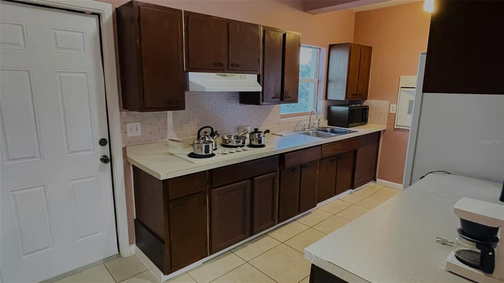 554 Lindley Terrace Port Charlotte, FL 33952 - Photo 18 of 57 a kitchen with stainless steel appliances a sink stove and cabinets