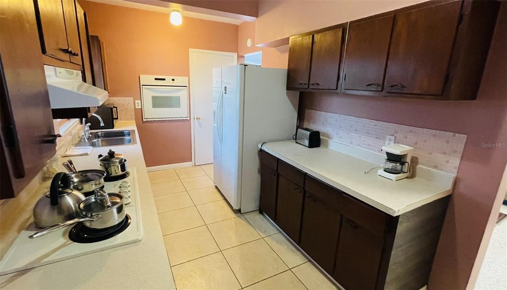 554 Lindley Terrace Port Charlotte, FL 33952 - Photo 19 of 57 a kitchen with a sink appliances and cabinets