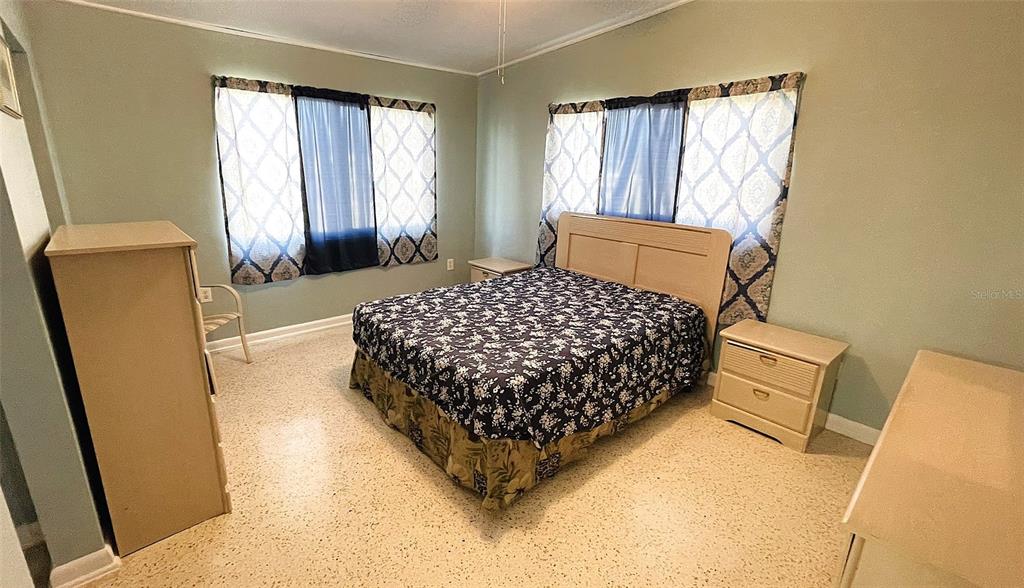 554 Lindley Terrace Port Charlotte, FL 33952 - Photo 22 of 57 a bedroom with a bed and wooden floor