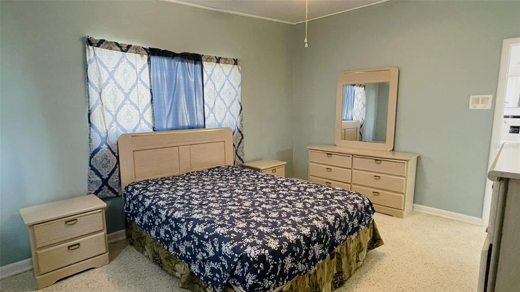 554 Lindley Terrace Port Charlotte, FL 33952 - Photo 25 of 57 a bedroom with a bed and a dresser